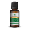 Pure peppermint essential oil bottle with fresh peppermint leaves